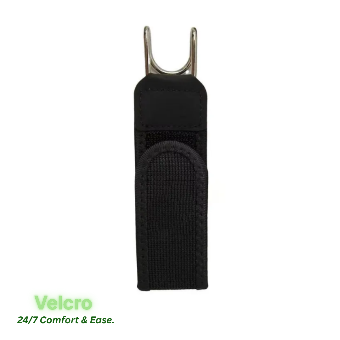 A black nylon Velcro belt with a silver metal clip at the top, shown on a white background with green text reading 'Velcro 24/7 Comfort & Ease.' in the lower left.